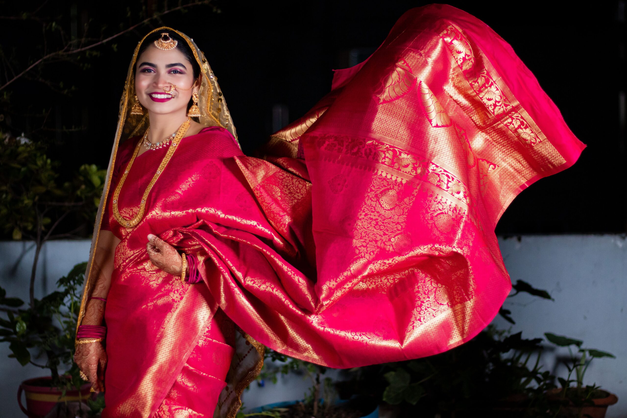 pexels photo 9345930 9345930 Smiling Indian woman in traditional red saree, showcasing Indian culture and fashion.